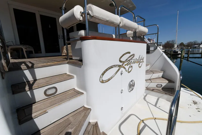 Slide: The Image of Luxury yacht deck with wooden steps, featuring Broward 100 model from 1984. - 8