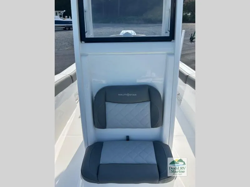 Slide: The Image of 2025 NauticStar 242 Offshore boat seat with gray upholstery and logo. - 10