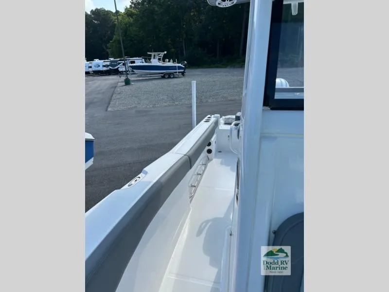 Slide: The Image of 2025 NauticStar 242 Offshore boat side view at Dodd RV Marine dealership. - 11