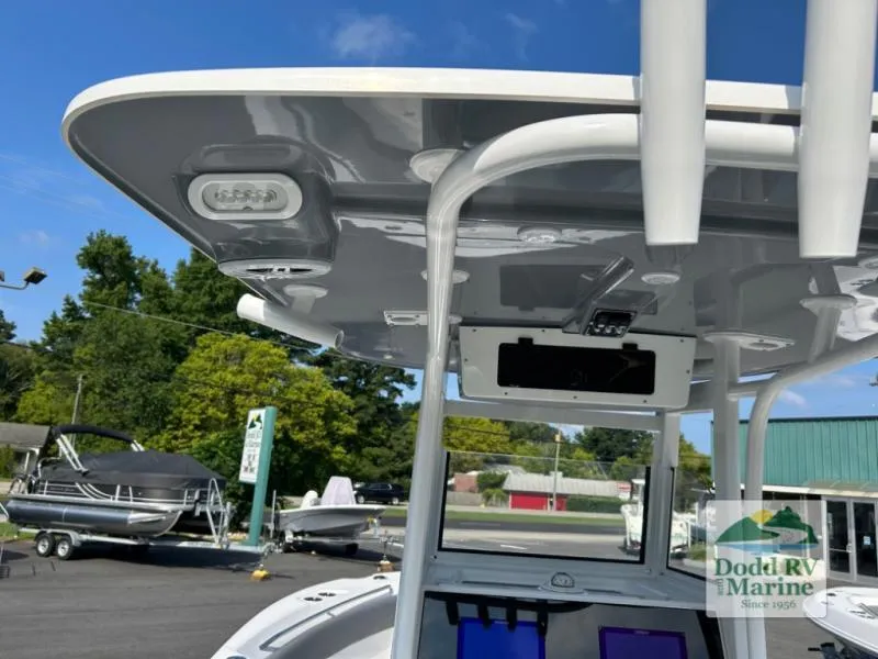 Slide: The Image of 2025 NauticStar 242 Offshore boat, showcasing T-top and electronics at Dodd RV Marine dealership. - 15