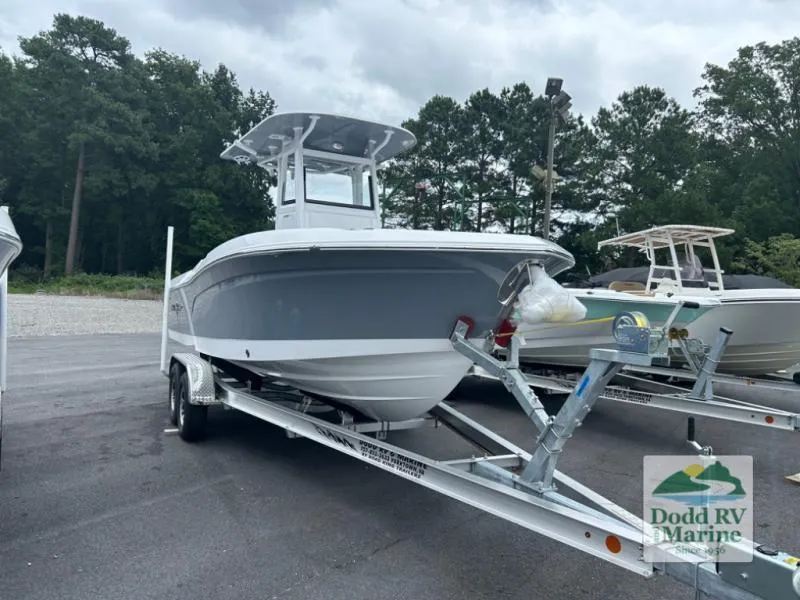 Slide: The Image of 2025 NauticStar 242 Offshore boat on trailer at Dodd RV Marine dealership. - 4