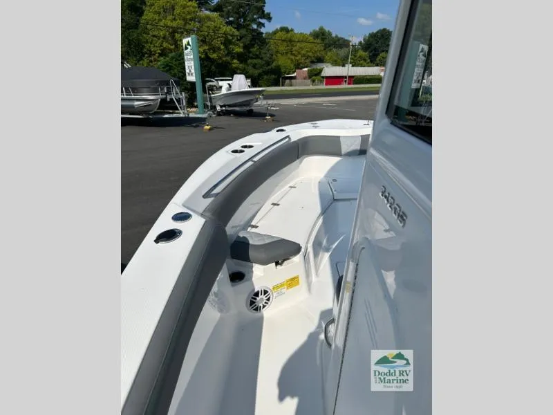 Slide: The Image of 2025 NauticStar 242 Offshore boat deck with seating, docked at Dodd RV Marine. - 5