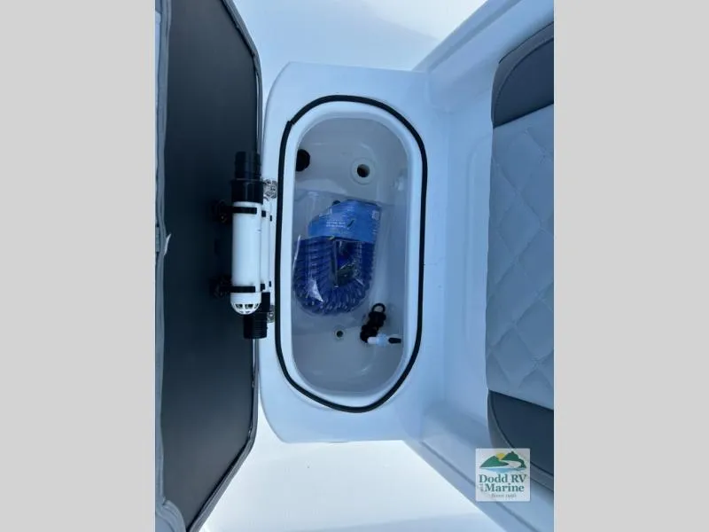 Slide: The Image of 2025 NauticStar 242 Offshore boat storage compartment with accessories. - 7