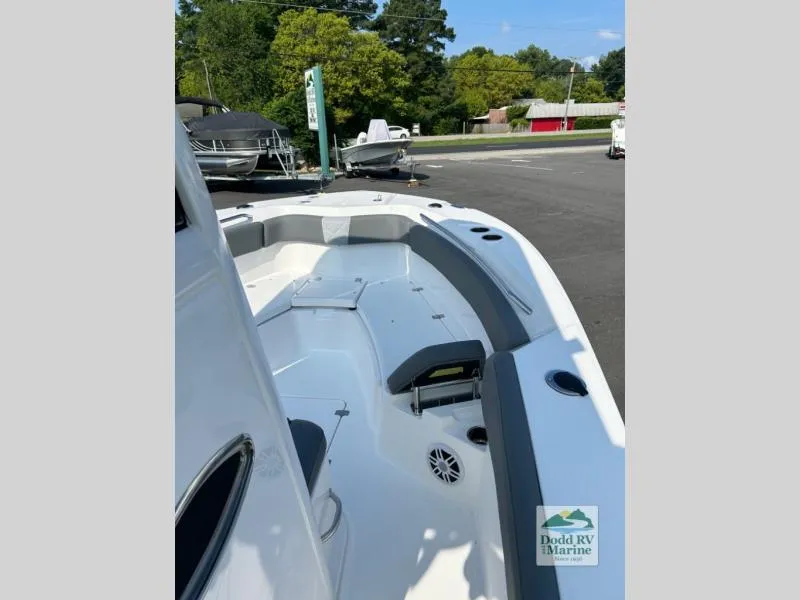 Slide: The Image of 2025 NauticStar 242 Offshore boat deck, spacious seating, parked outdoors. - 8