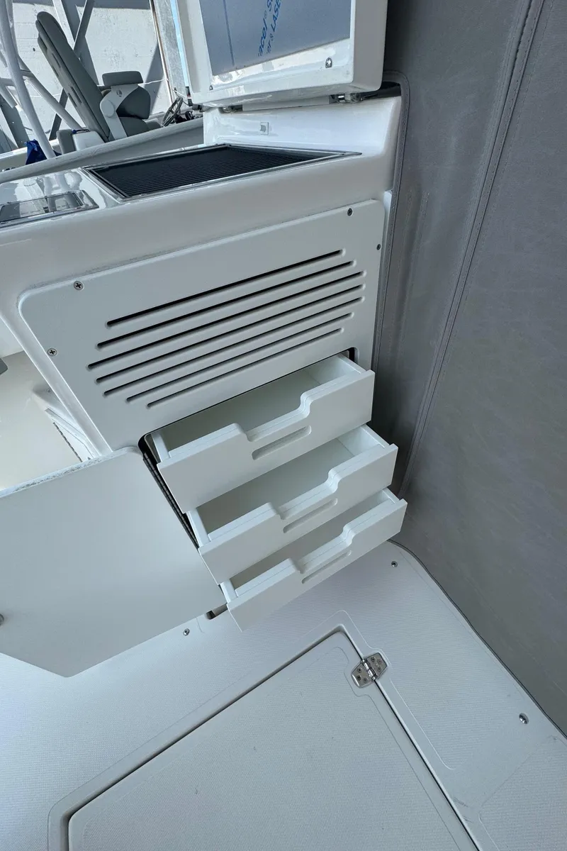 Slide: The Image of 2025 NorthCoast 315 HT interior with open storage drawers and control panel. - 10