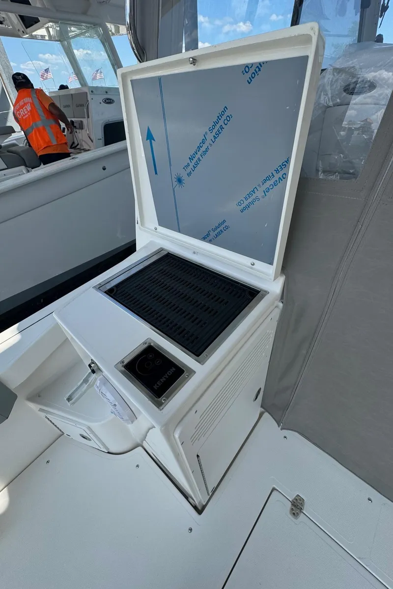 Slide: The Image of 2025 NorthCoast 315 HT boat interior with open storage compartment. - 11
