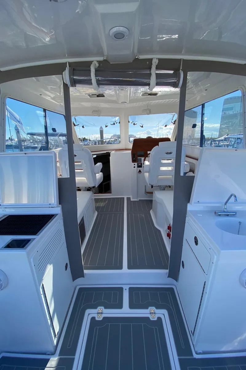 Slide: The Image of 2025 NorthCoast 315 HT boat interior with modern seating and sleek design. - 7