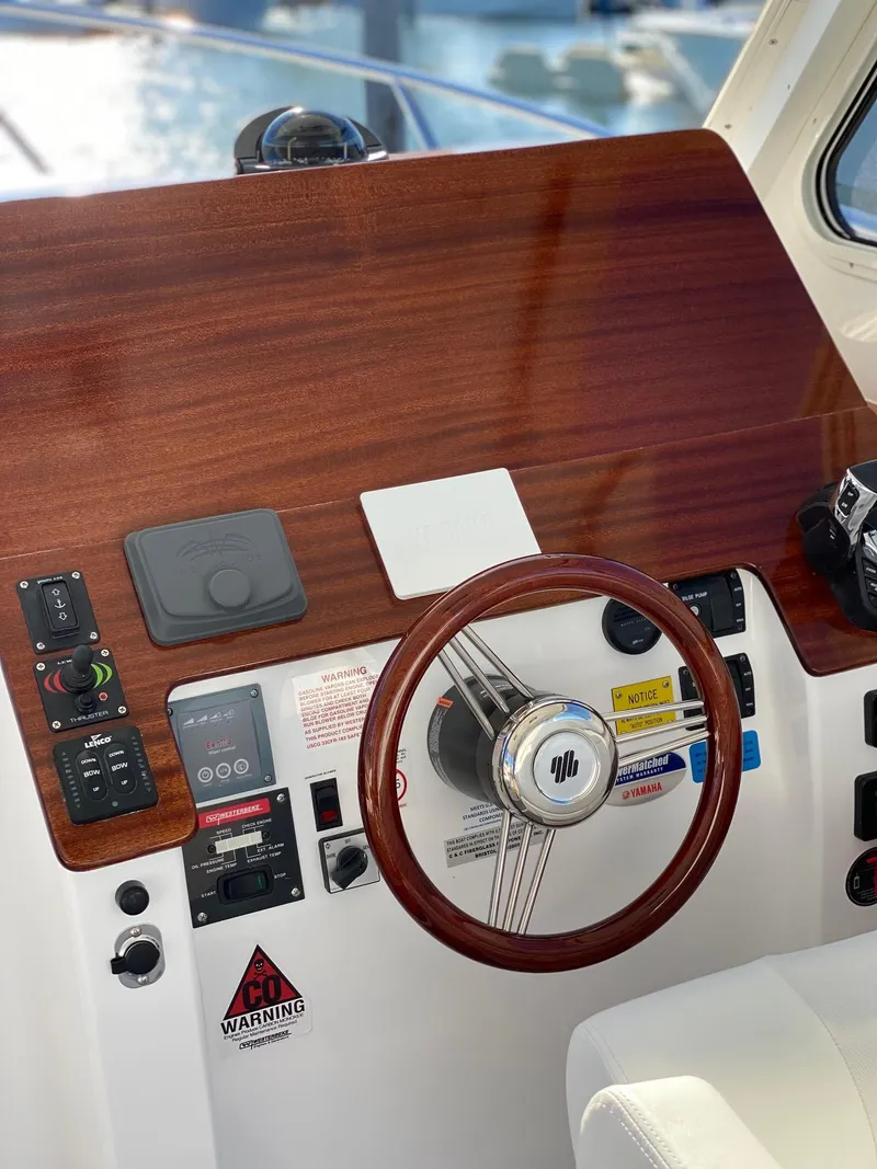 Slide: The Image of 2025 NorthCoast 315 HT helm with wooden dashboard and modern controls. - 8