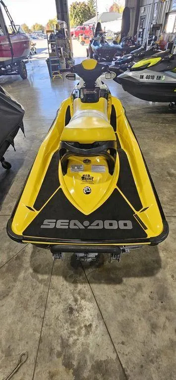 Slide: The Image of 2009 Sea-Doo RXT™ 215 jet ski in a showroom, yellow and black design. - 4