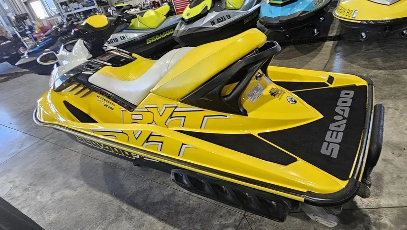 Slide: The Image of 2009 Sea-Doo RXT™ 215 jet ski in vibrant yellow, displayed indoors. - 5