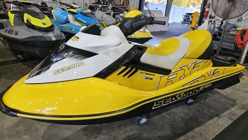 Slide: The Image of 2009 Sea-Doo RXT™ 215 jet ski in yellow and white, displayed indoors. - 7