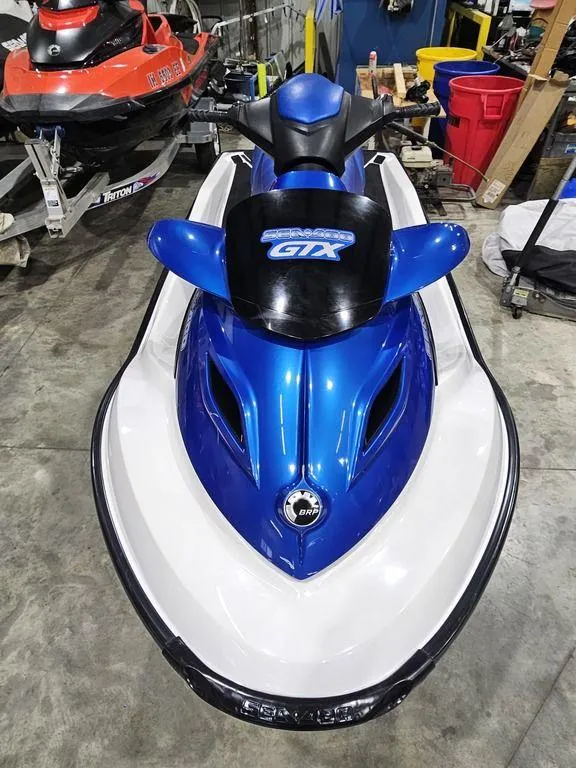 Slide: The Image of 2007 Sea-Doo GTX 4-TEC™ jet ski in blue and white, parked indoors. - 3