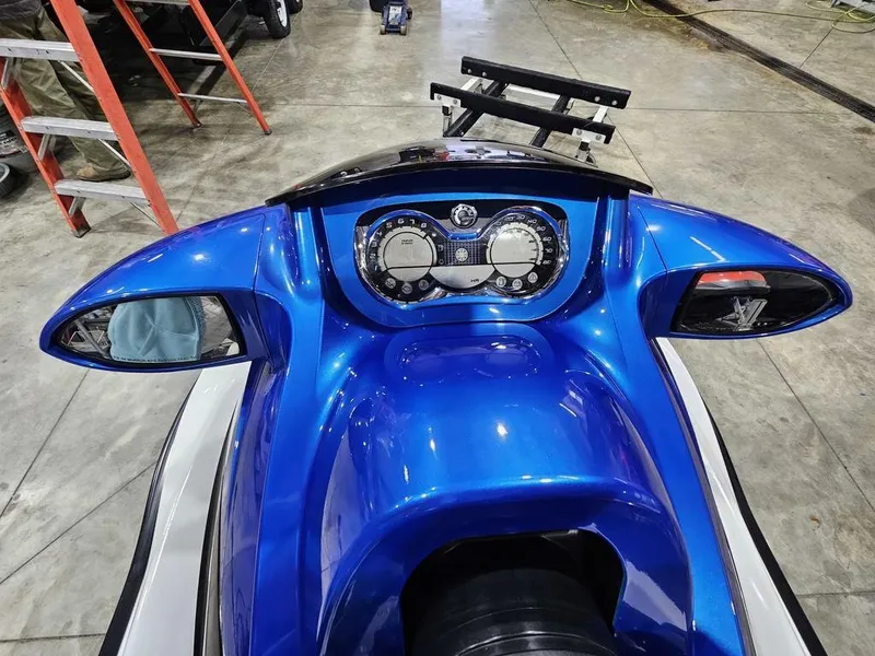 Slide: The Image of 2007 Sea-Doo GTX 4-TEC™ dashboard with blue finish and dual mirrors in a garage setting. - 7