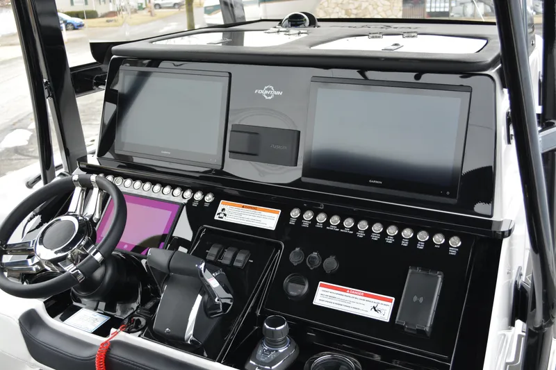 Slide: The Image of 2025 Fountain 34 CC boat dashboard with advanced navigation displays and controls. - 11