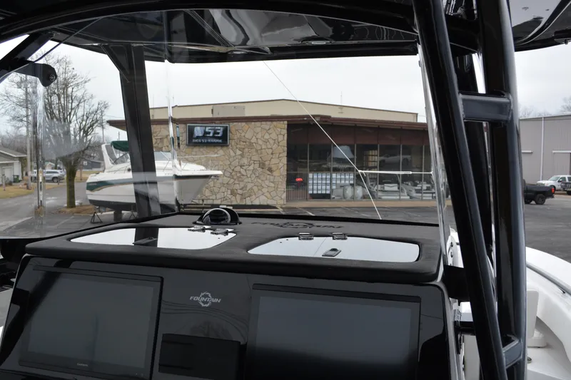 Slide: The Image of 2025 Fountain 34 CC boat dashboard with marina background. - 12