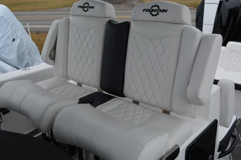 Slide: The Image of 2025 Fountain 34 CC boat seats with white diamond stitching and logo. - 13