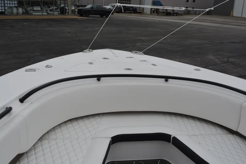 Slide: The Image of 2025 Fountain 34 CC boat bow with white cushioned seating and diamond-patterned flooring. - 19