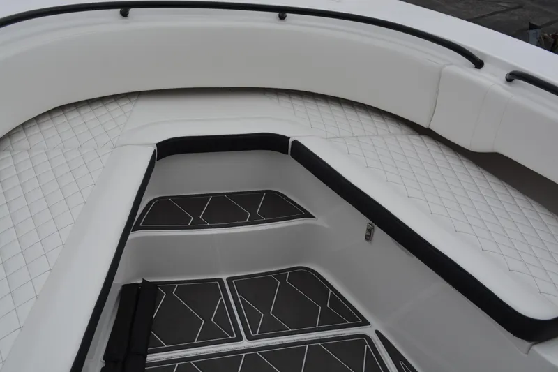 Slide: The Image of 2025 Fountain 34 CC boat interior with cushioned seating and textured flooring. - 20