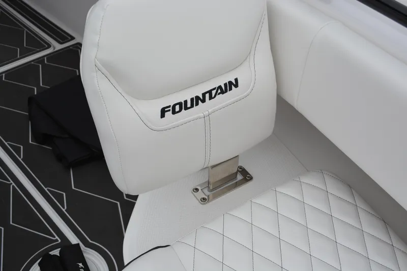 Slide: The Image of 2025 Fountain 34 CC boat seat with white upholstery and logo detailing. - 24