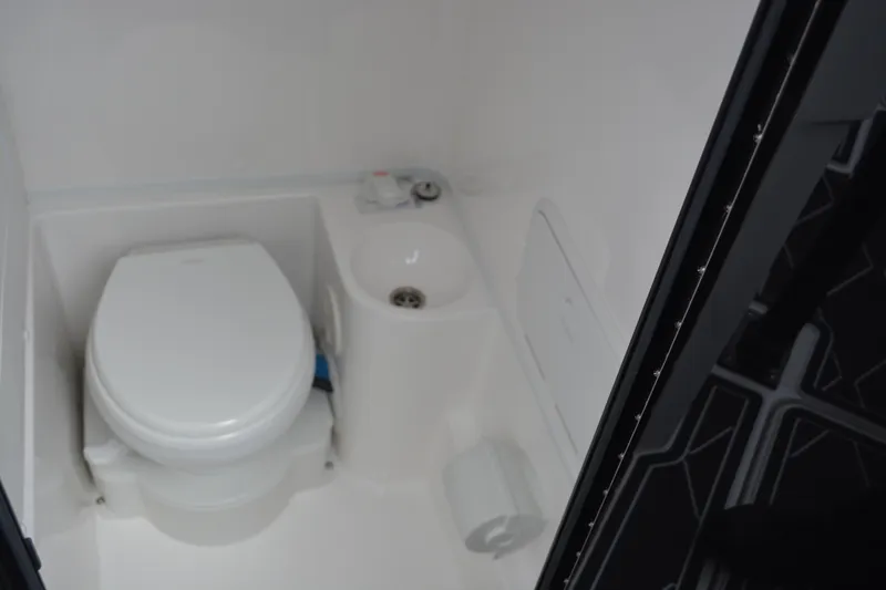 Slide: The Image of 2025 Fountain 34 CC boat bathroom interior with toilet and sink. - 28
