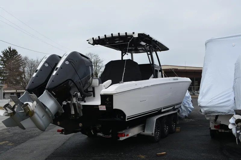 Slide: The Image of 2025 Fountain 34 CC boat with dual outboard engines on a trailer. - 3
