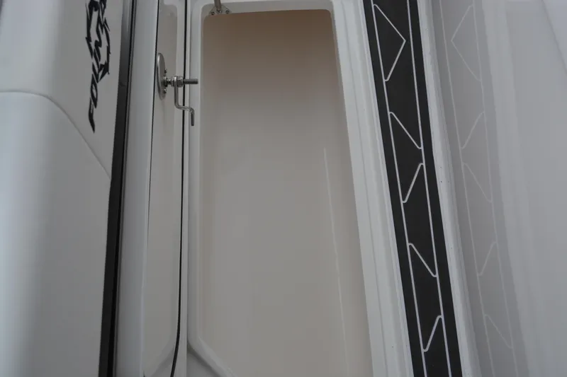 Slide: The Image of 2025 Fountain 34 CC boat storage compartment with sleek design and secure latch. - 33
