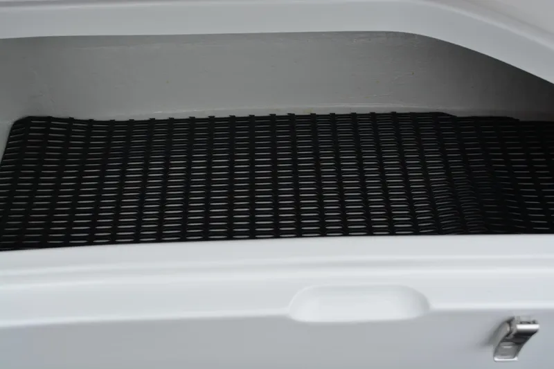Slide: The Image of Storage compartment of 2025 Fountain 34 CC boat with black grid mat. - 39