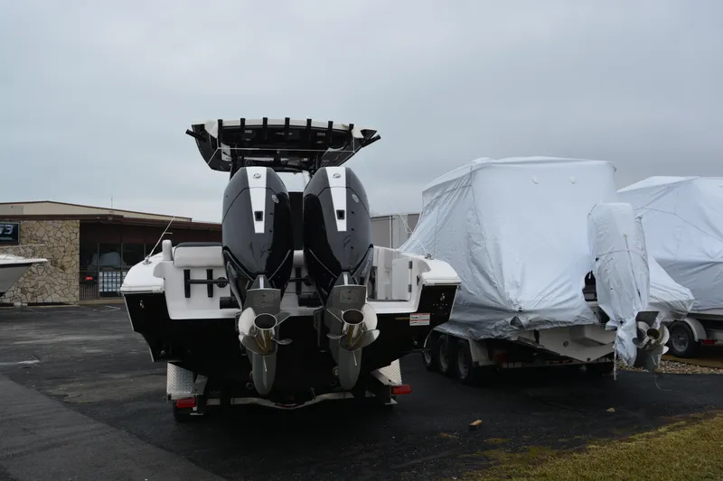 Slide: The Image of 2025 Fountain 34 CC boat with dual outboard motors in a storage area. - 4