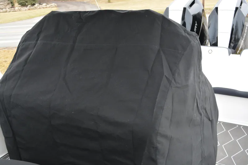 Slide: The Image of 2025 Fountain 34 CC boat with covered engine, black protective cover. - 8