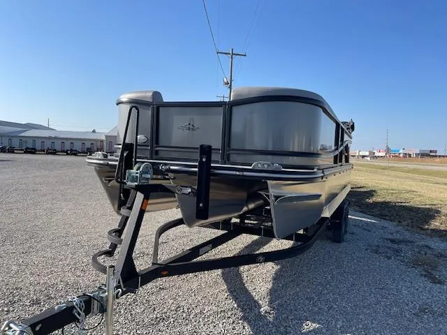 Slide: The Image of 2025 SunCatcher Fusion 324RC pontoon boat on trailer, parked outdoors. - 11