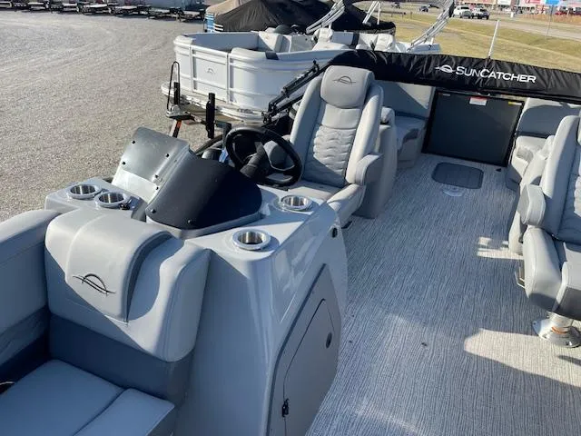 Slide: The Image of 2025 SunCatcher Fusion 324RC pontoon boat interior with plush seating and modern helm. - 16