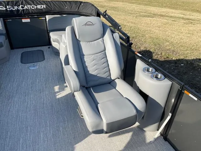 Slide: The Image of 2025 SunCatcher Fusion 324RC boat interior with plush seating and cup holders. - 18
