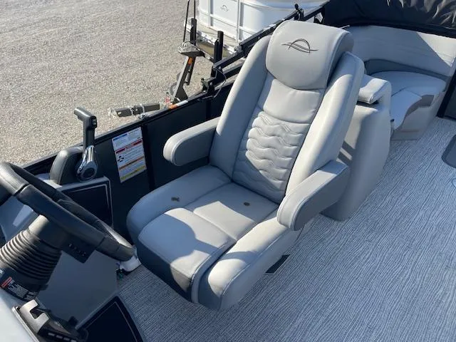 Slide: The Image of Captain's chair in 2025 SunCatcher Fusion 324RC boat, featuring sleek design and controls. - 19