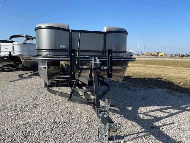 Slide: The Image of 2025 SunCatcher Fusion 324RC pontoon boat on gravel lot, front view. - 2