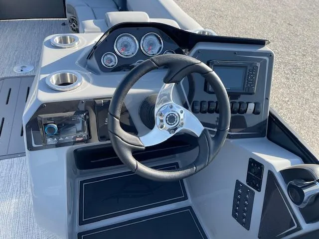 Slide: The Image of Cockpit of 2025 SunCatcher Fusion 324RC boat with steering wheel and control panel. - 20
