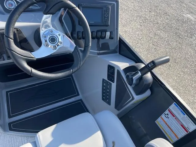 Slide: The Image of Interior view of 2025 SunCatcher Fusion 324RC boat cockpit with steering wheel and controls. - 21