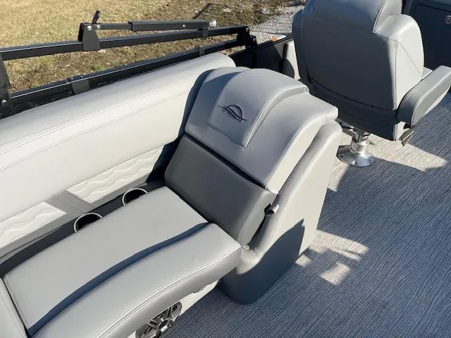Slide: The Image of 2025 SunCatcher Fusion 324RC boat interior with gray seating and cup holders. - 25