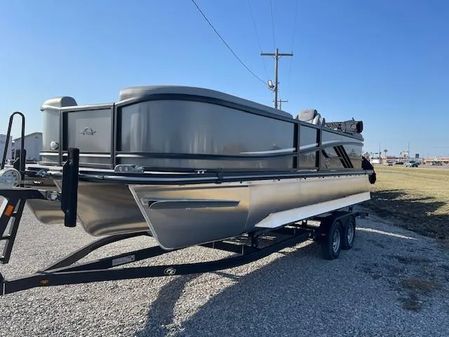 Slide: The Image of 2025 SunCatcher Fusion 324RC pontoon boat on trailer, parked outdoors. - 3