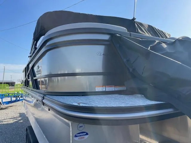 Slide: The Image of 2025 SunCatcher Fusion 324RC pontoon boat, silver exterior, covered, parked outdoors. - 30
