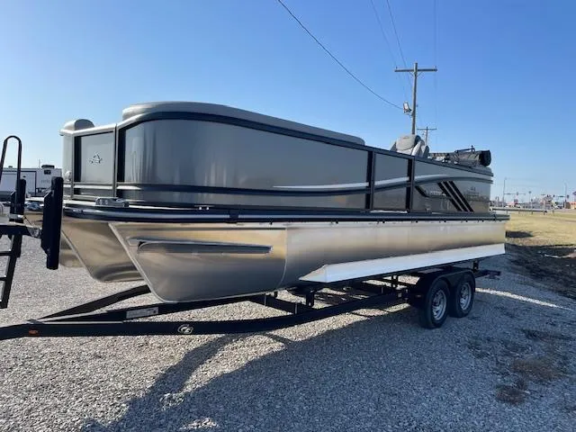 Slide: The Image of 2025 SunCatcher Fusion 324RC pontoon boat on a trailer, parked outdoors. - 9