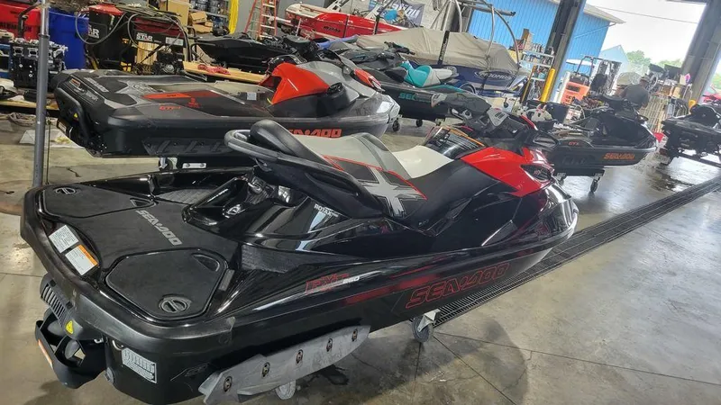 Slide: The Image of 2014 Sea-Doo RXT-X 260 jet ski in a workshop setting. - 3
