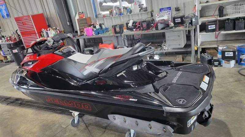 Slide: The Image of 2014 Sea-Doo RXT-X 260 jet ski in a workshop setting. - 4
