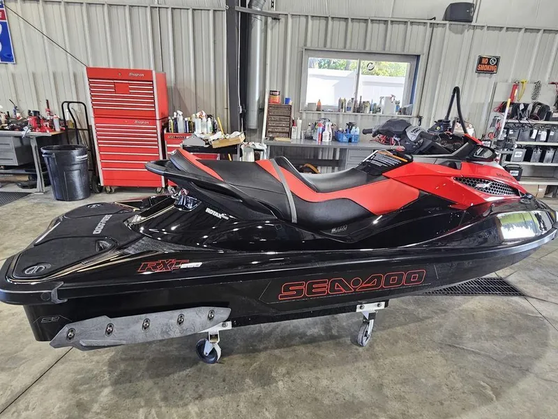Slide: The Image of 2014 Sea-Doo RXT-X 260 jet ski in a workshop setting. - 5