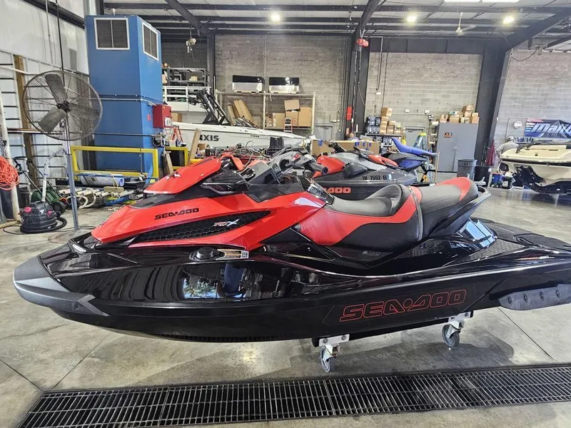 Slide: The Image of 2014 Sea-Doo RXT-X 260 jet ski in a warehouse setting. - 8