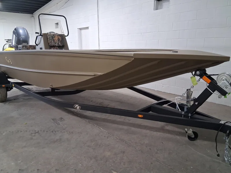 Slide: The Image of 2025 G3 Gator Tough 18 CC boat on trailer in a garage setting. - 1