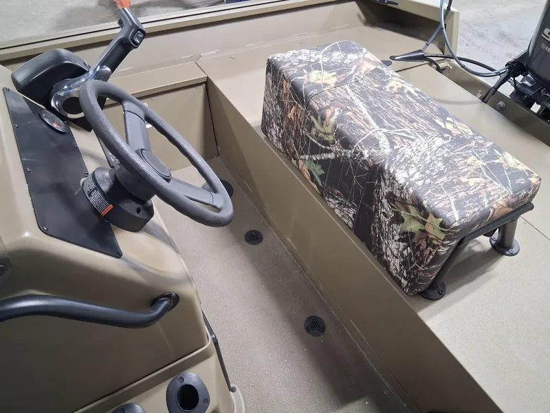 Slide: The Image of 2025 G3 Gator Tough 18 CC boat interior with camo seat and steering wheel. - 13