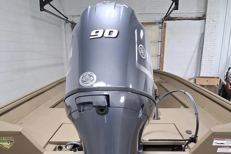 Slide: The Image of 2025 G3 Gator Tough 18 CC boat with 90 HP outboard motor in a garage. - 3