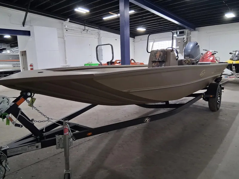Slide: The Image of 2025 G3 Gator Tough 18 CC boat on trailer in indoor showroom. - 5
