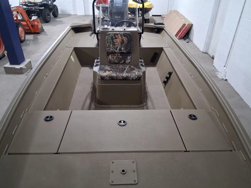 Slide: The Image of 2025 G3 Gator Tough 18 CC boat interior with camouflage seating in a garage setting. - 6