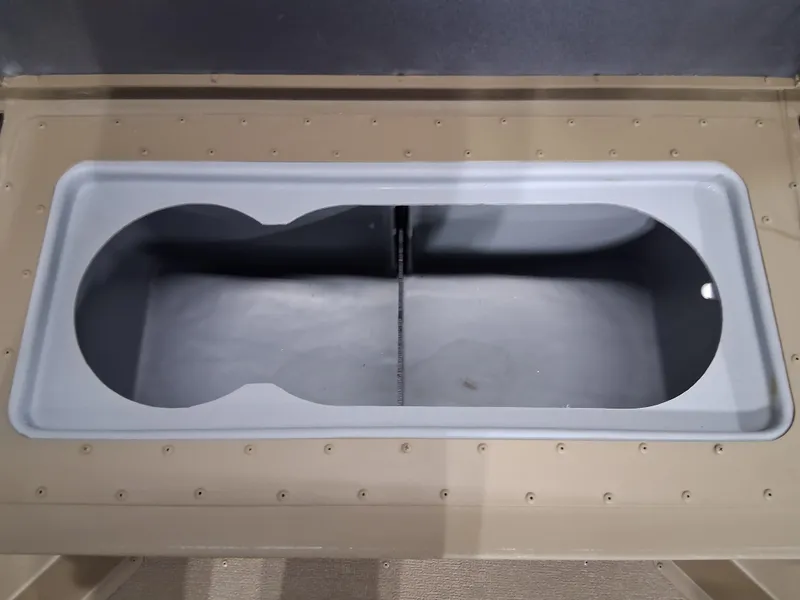 Slide: The Image of 2025 G3 Gator Tough 18 CC boat storage compartment, beige interior, open lid view. - 9